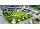 Aerial view of a park, recreational area, and commercial buildings in a planned community at 295 Sagamore Nw Cv, Sugar Hill, GA 30518