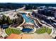 Aerial view of an outdoor amphitheater, surrounded by a pond, walking path, and commercial spaces at 295 Sagamore Nw Cv, Sugar Hill, GA 30518