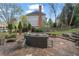 Backyard patio featuring stone flooring, outdoor seating, landscaping, and a cozy ambiance at 295 Sagamore Nw Cv, Sugar Hill, GA 30518