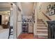 Basement bar area featuring a wine fridge and a stylish display of liquor bottles at 295 Sagamore Nw Cv, Sugar Hill, GA 30518