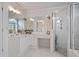 Bathroom featuring white cabinets, a sleek vanity with a large mirror, and a glass-enclosed shower at 295 Sagamore Nw Cv, Sugar Hill, GA 30518