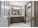 Well-lit bathroom with double sink vanity, framed mirror, and separate toilet room at 295 Sagamore Nw Cv, Sugar Hill, GA 30518