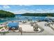 Scenic beach view with umbrellas, piers, boats, and the surrounding lake and trees at 295 Sagamore Nw Cv, Sugar Hill, GA 30518