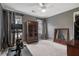Bedroom with neutral colors, a ceiling fan, and two windows providing natural light, perfect for exercise at 295 Sagamore Nw Cv, Sugar Hill, GA 30518