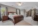 Spacious bedroom featuring a large bed, multiple windows, and a ceiling fan at 295 Sagamore Nw Cv, Sugar Hill, GA 30518