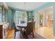 Cozy dining room with a vintage cabinet, seating for four, and an open layout at 295 Sagamore Nw Cv, Sugar Hill, GA 30518