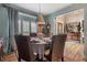 Elegant dining room with large window, chandelier, and comfortable seating at 295 Sagamore Nw Cv, Sugar Hill, GA 30518