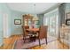 Charming dining room featuring wood floors, a large window, and room for four chairs at 295 Sagamore Nw Cv, Sugar Hill, GA 30518