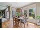 Bright dining room with large windows, hardwood floors, and views of the outdoor living space at 295 Sagamore Nw Cv, Sugar Hill, GA 30518