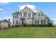 Charming two-story home with manicured lawn and traditional design elements at 295 Sagamore Nw Cv, Sugar Hill, GA 30518