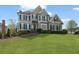 Beautiful two-story home features a manicured lawn, classic shutters, and a stately entrance at 295 Sagamore Nw Cv, Sugar Hill, GA 30518