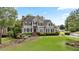 Attractive two-story home with a lush green lawn and well-maintained landscaping at 295 Sagamore Nw Cv, Sugar Hill, GA 30518