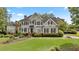 Charming two-story home with manicured lawn, shutters and lovely landscaping at 295 Sagamore Nw Cv, Sugar Hill, GA 30518