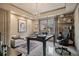 This home office features a decorative chandelier, a stylish rug, and lots of natural light from the window at 295 Sagamore Nw Cv, Sugar Hill, GA 30518
