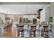 Stylish kitchen features counter seating, granite countertops, stainless steel appliances, and hardwood floors at 295 Sagamore Nw Cv, Sugar Hill, GA 30518