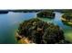 Picturesque lake view of tree-covered islands dotting the calm, clear waters at 295 Sagamore Nw Cv, Sugar Hill, GA 30518
