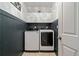 Well-organized laundry room with modern washer and dryer and overhead cabinets at 295 Sagamore Nw Cv, Sugar Hill, GA 30518