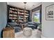 Charming library featuring built-in bookshelves, comfortable seating, and natural light at 295 Sagamore Nw Cv, Sugar Hill, GA 30518