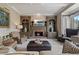Inviting living room features built-in shelving, a brick fireplace, and a cozy seating arrangement at 295 Sagamore Nw Cv, Sugar Hill, GA 30518