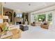 Spacious living room with a cozy fireplace, built-in shelves, and abundant natural light at 295 Sagamore Nw Cv, Sugar Hill, GA 30518