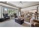 Bright and airy living room featuring a large window, comfortable seating, and open access to the kitchen at 295 Sagamore Nw Cv, Sugar Hill, GA 30518