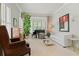 Elegant living room with neutral tones, large windows, and a stylish decor at 295 Sagamore Nw Cv, Sugar Hill, GA 30518