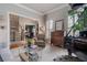 Cozy living room with piano, large windows and hardwood floors at 295 Sagamore Nw Cv, Sugar Hill, GA 30518