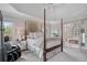 Comfortable main bedroom with a view of the ensuite, featuring a trey ceiling and ample natural light at 295 Sagamore Nw Cv, Sugar Hill, GA 30518
