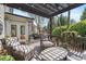 Relaxing outdoor patio area with a grill and comfortable seating with string lights above at 295 Sagamore Nw Cv, Sugar Hill, GA 30518