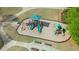 Aerial view of the community playground featuring slides, climbing structures, and benches at 295 Sagamore Nw Cv, Sugar Hill, GA 30518