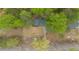 Aerial view of a home nestled among lush trees with a long driveway at 4695 Waters Rd, Woodstock, GA 30188