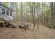Backyard featuring a wooden deck, grill and patio furniture set among the trees at 4695 Waters Rd, Woodstock, GA 30188