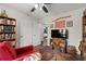 Inviting bedroom featuring bookshelves, a cozy red chair, and colorful artwork at 4695 Waters Rd, Woodstock, GA 30188