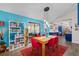 Bright dining area with blue accent wall, modern light fixture and doorway to kitchen at 4695 Waters Rd, Woodstock, GA 30188