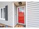Close-up of a bright red front door with glass panels and dark shutters at 4695 Waters Rd, Woodstock, GA 30188