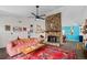 Cozy living room features a stone fireplace, eclectic decor, and a colorful rug at 4695 Waters Rd, Woodstock, GA 30188