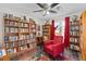 Home office featuring built-in bookshelves, hardwood floors, a ceiling fan and natural light at 4695 Waters Rd, Woodstock, GA 30188