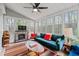 Cozy sunroom with stone fireplace, fan, and natural light at 4695 Waters Rd, Woodstock, GA 30188