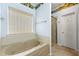 Bathroom featuring a soaking tub, a separate shower, and scenic wallpaper at 545 Goldfinch Way, Stockbridge, GA 30281