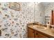 Traditional bathroom with floral wallpaper and a vintage-style vanity at 545 Goldfinch Way, Stockbridge, GA 30281