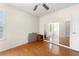 Sunlit bedroom with hardwood floors and a wall-sized mirror at 545 Goldfinch Way, Stockbridge, GA 30281