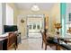 Bright dining room with stone-tile table set and French doors leading to sunny backyard at 545 Goldfinch Way, Stockbridge, GA 30281