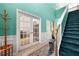 Bright entryway with wood flooring, paneled walls, a staircase and French doors at 545 Goldfinch Way, Stockbridge, GA 30281