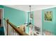 Upstairs view of the living room with a fan, two-story window, and decoratively paneled wall at 545 Goldfinch Way, Stockbridge, GA 30281