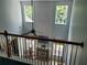 Bright, two-story living room featuring a fireplace, large windows, and a ceiling fan above at 545 Goldfinch Way, Stockbridge, GA 30281