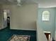 Loft area overlooking foyer featuring a ceiling fan, doorway to another room, and a decorative rug at 545 Goldfinch Way, Stockbridge, GA 30281