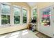 Charming sunroom with large windows, storage shelves, and access to the backyard at 545 Goldfinch Way, Stockbridge, GA 30281
