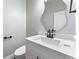 Chic powder room with marble countertop, modern sink and mirror, plus sleek fixtures at 6091 Wayfarer Dr, Villa Rica, GA 30180