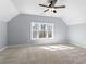 Bedroom featuring a ceiling fan and a view of the outdoors through the windows at 6091 Wayfarer Dr, Villa Rica, GA 30180
