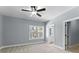 Spacious bedroom with ceiling fan and view of the outdoors through the windows at 6091 Wayfarer Dr, Villa Rica, GA 30180